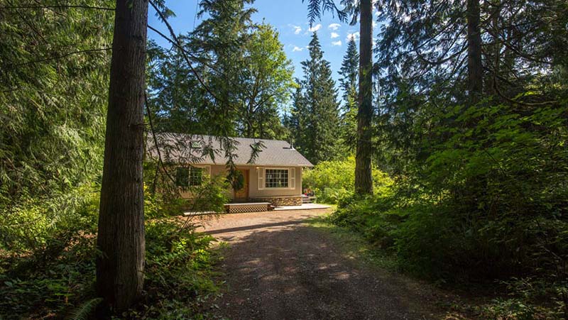 cottage tucked in a forest setting